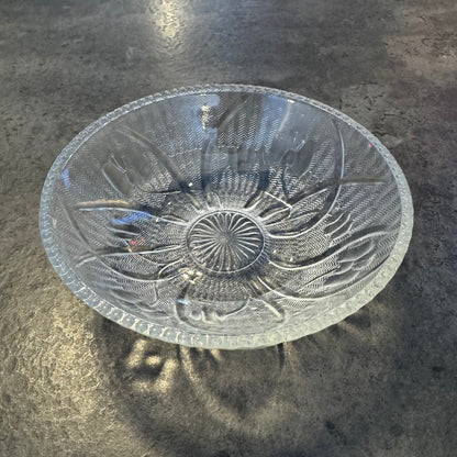 Decorative glass bowl with floral patterns on a dark surface