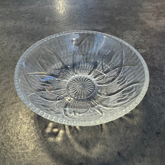 Decorative glass bowl with floral patterns on a dark surface