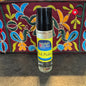 Perfume oil bottle labeled 'Moonlight Rose' with colorful embroidered fabric in the background