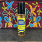 Perfume oil bottle labeled 'Nag Champa Flora' with a colorful embroidered background